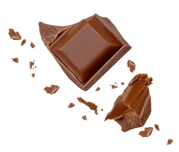 istock Flying chocolate pieces isolated on white background. Broken choco chunks with crumbs  Top view. Flat lay 2094646112