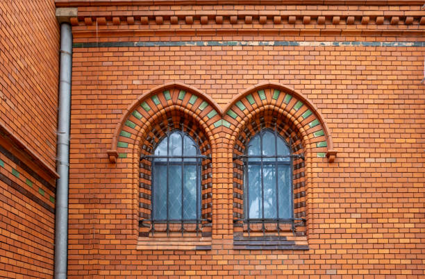 Arch windows in the facade, made of brick tiles, of the Church of Visitation of Virgin Many . Neo-gothic building on the place of historical church. Postorna, Breclav, Moravia, Czech republic.