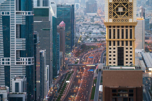 Navigate through the heart of Downtown Dubai along Sheik Zayed City Highway, flanked by impressive modern skyscrapers that define the iconic skyline of the United Arab Emirates. This landmark cityscape captivates with its blend of architectural marvels and bustling urban life
