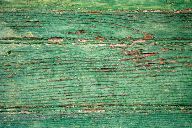 wooden background formed of oblique boards with shabby green paint
