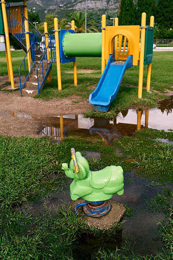 Swing-balancer on a spring on a playground after rain. High quality photo