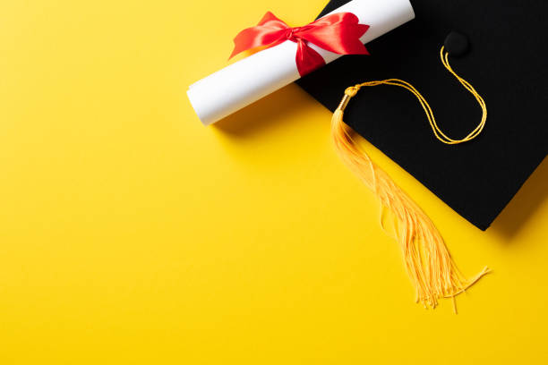 istock Flat lay composition with graduation cap and diploma on yellow background. 2094686571