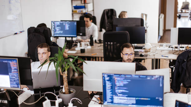 istock Group of male and female computer programmers working on computer at the open space office 2094687097