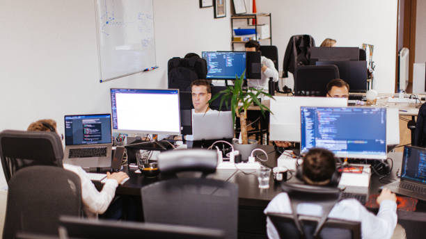 istock Group of male and female computer programmers working on computer at the open space office 2094687657