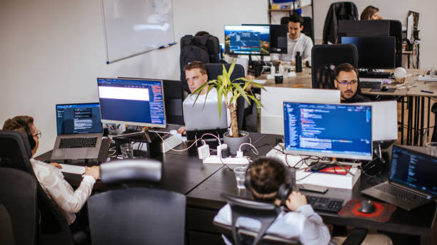 istock Group of male and female computer programmers working on computer at the open space office 2094688703