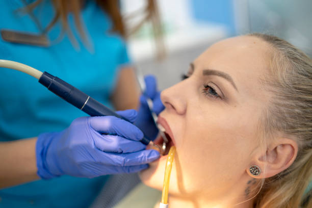 istock Young woman having her teeth checked during appointment at dentist's office. s 2094689245