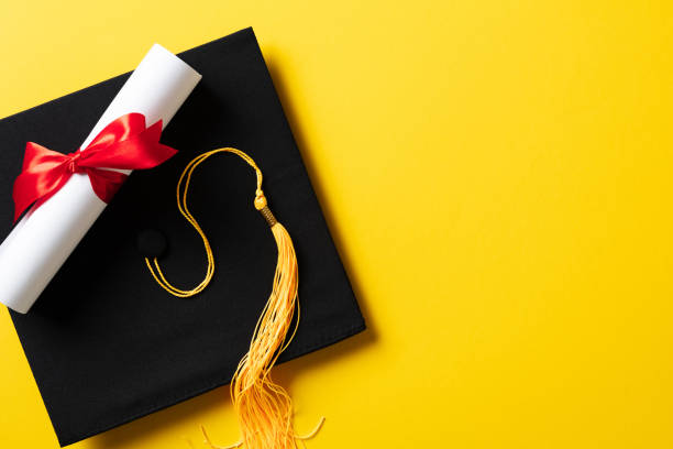 istock Flat lay composition with graduation hat and diploma on yellow background 2094690854