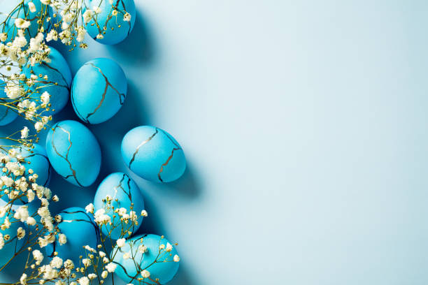 istock Dyed Easter eggs with flowers on pastel blue background. Top view. Flat lay. 2094695749