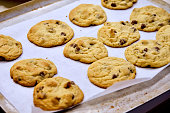 Freshly Baked, Homemade Chocolate Chip Cookies Cooling on Baking Tray