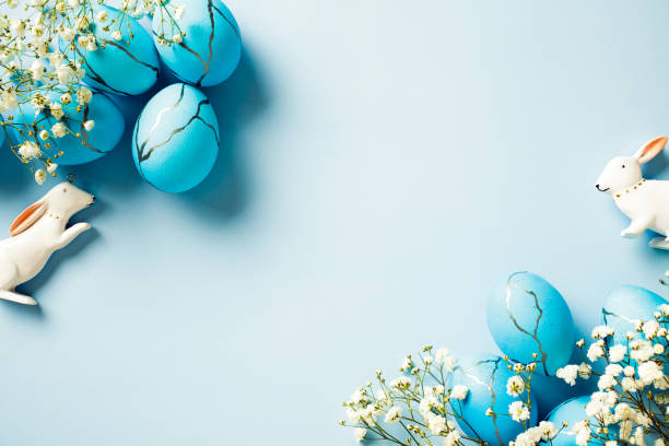 istock Easter poster and banner template with dyed Easter eggs, spring flowers, bunny on pastel blue background. 2094698984