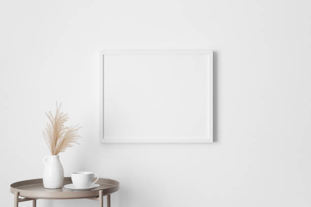 istock White frame mockup on the wall with a pampas decoration. 2094699543