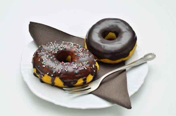 Two Chocolate Donuts on white Plate stock photo
