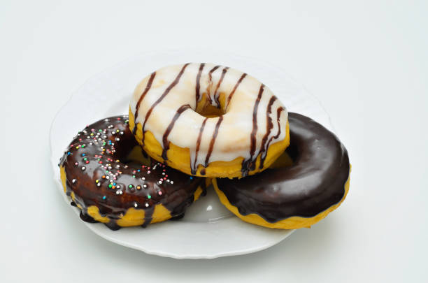 Three assorted Donuts on white Plate stock photo