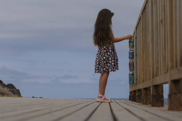 girl recycling on the beach contributing to sustainable development, caring for the environment and sea waters