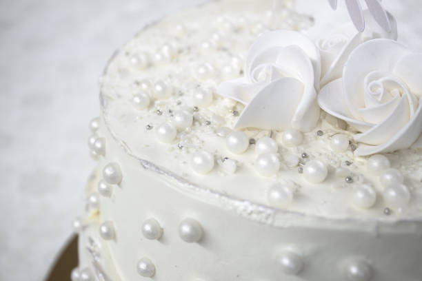istock White party cake with white icing and pearls, cake design. Handmade cake made for a special celebratory occasion. Special details. 2094722744