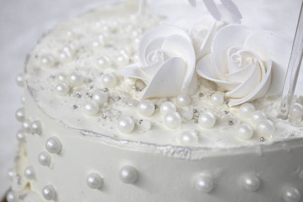 istock White party cake with white icing and pearls, cake design. Handmade cake made for a special celebratory occasion. Special details. 2094722753