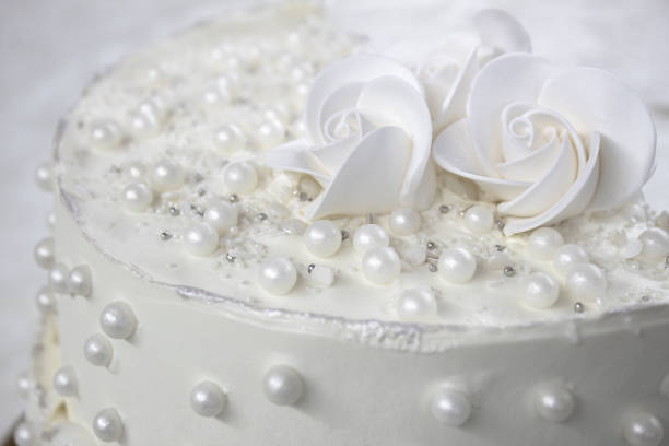 istock White party cake with white icing and pearls, cake design. Handmade cake made for a special celebratory occasion. Special details. 2094722754
