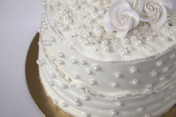 istock White party cake with white icing and pearls, cake design. Handmade cake made for a special celebratory occasion. Special details. 2094722759