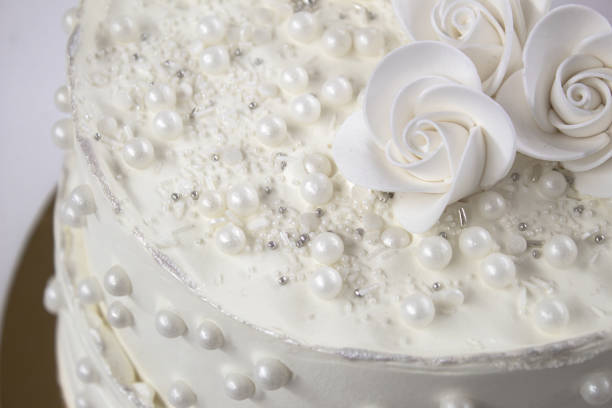 istock White party cake with white icing and pearls, cake design. Handmade cake made for a special celebratory occasion. Special details. 2094723188