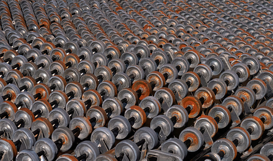 close up of a retail display of an old rusty and weathered skate wheel conveyor belt for sale at a junkyard, Long Island, New York State