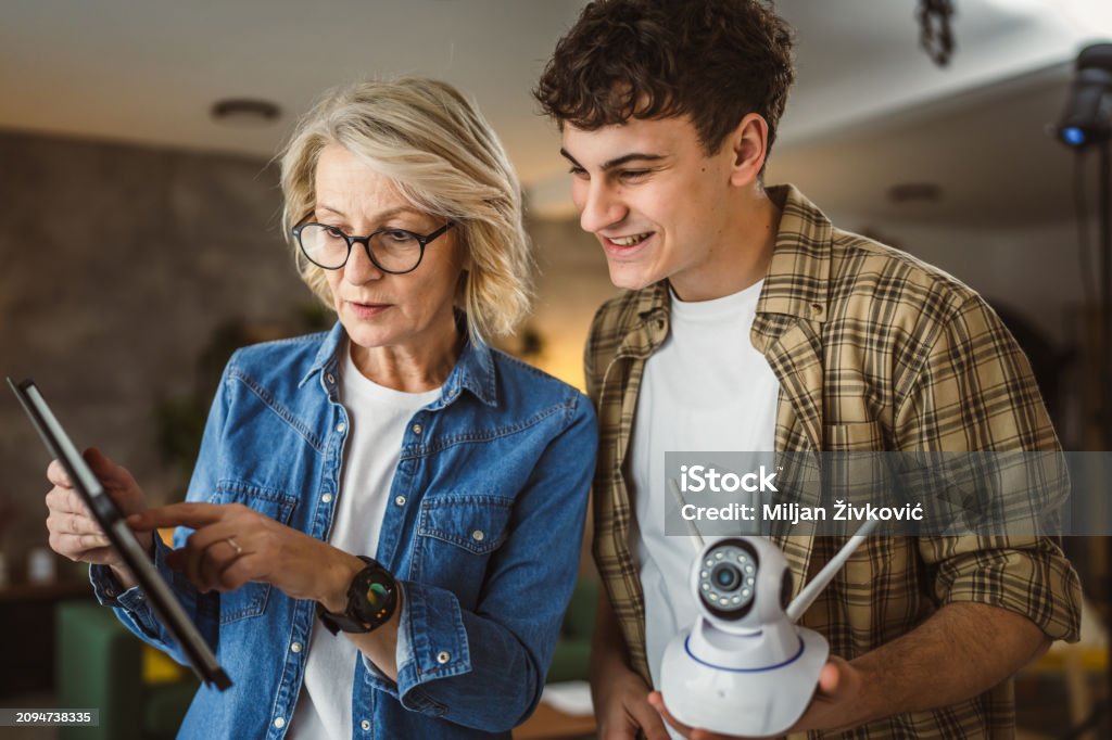 Mother And Son Adjust And Install Home Cctv Video Surveillance Camera