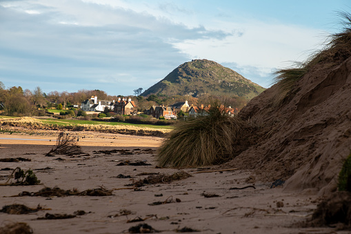 View on North Berwick Law, a hill and buildings in West Side of North Berwick from the beach