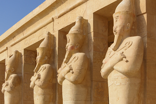 Four queen Hatshepsut statues  in Hatshepsut temple in the valley of the kings, Egypt, blue sky