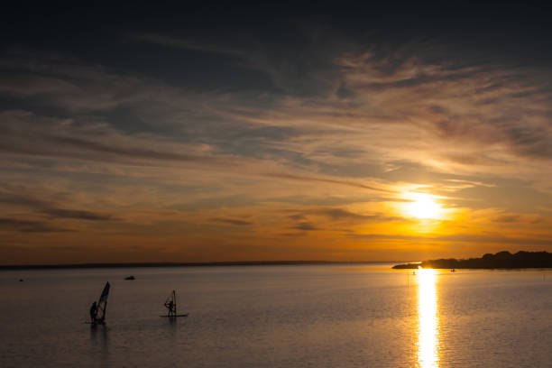 istock Windsurfing on the lake at sunset 2094785071