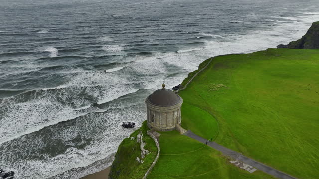 Aerial view of Mussenden Temple library in Northern Ireland, Downhill, County Londonderry, Ruin of Mussenden temple on the edge of a cliff, Aerial view of Causeway Beach and Mussenden Temple, Mussenden Temple on high cliffs near Castlerock