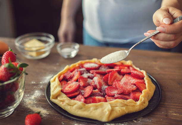 istock Woman preparing strawberry galette or open strawberry pie 2094818743
