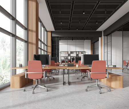 Contemporary open plan office interior with conference room. Window, wooden wall, table, office chairs with office desks and computers, projector screen, pendant lamps and plant. Template for copy space. Render.