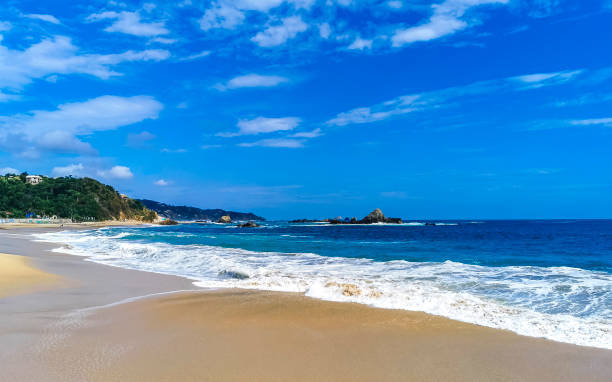 istock Mazunte Mexico most beautiful paradise beach with mountains cliffs rocks waves. 2094909395