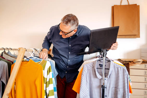 istock Man packing goods and preparing it for delivery service using laptop to complete order 2094911557