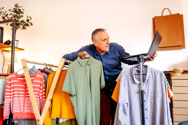 istock Man packing goods and preparing it for delivery service using laptop to complete order 2094911758