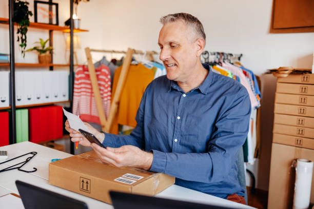 istock Man packing goods preparing it for delivery service 2094912601