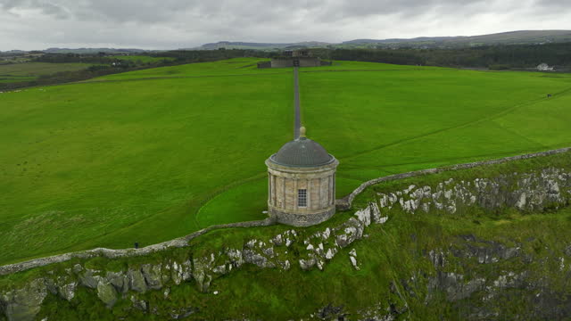 Aerial view of Mussenden Temple library in Northern Ireland, Downhill, County Londonderry, Ruin of Mussenden temple on the edge of a cliff, Aerial view of Causeway Beach and Mussenden Temple, Mussenden Temple on high cliffs near Castlerock