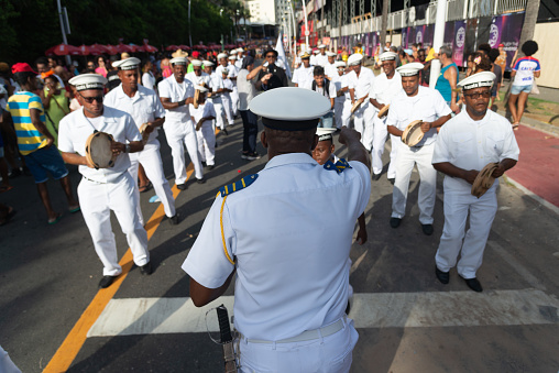 Salvador, Bahia, Brazil - February 03, 2024: Members of the cultural group Fragata Brasileira are seen parading during Fuzue, pre-carnival in the city of Salvador, Bahia.