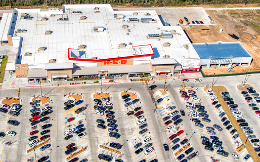 Manvel, United States - February 13, 2024:  Aerial view of a newly built HEB grocery store located in the suburban Houston town of Manvel, Texas located about 30 miles south of downtown Houston shot via helicopter from an altitude of about 600 feet.