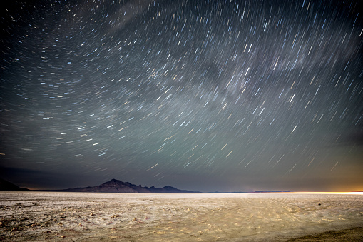 Star trails in the background of a salt flat desert