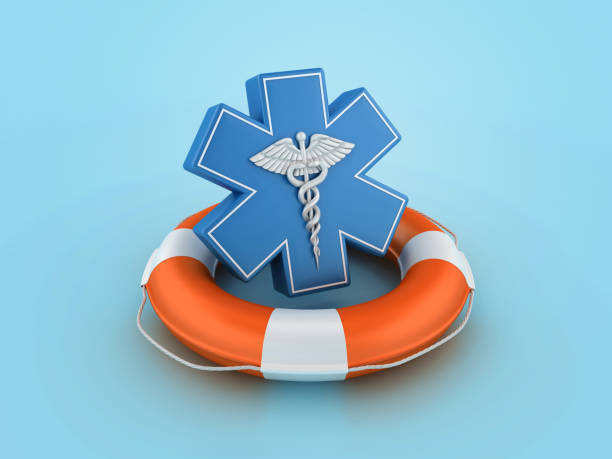 A close-up view of a medical cross symbol against a clear blue sky.
