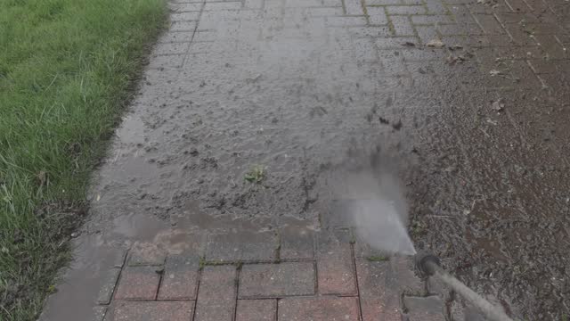 Block paving being cleaned with jet washer