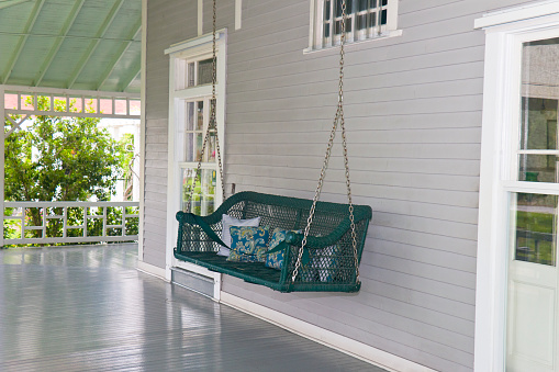 Lanai of a traditional southern home with a porch swing in southwest Florida, USA.