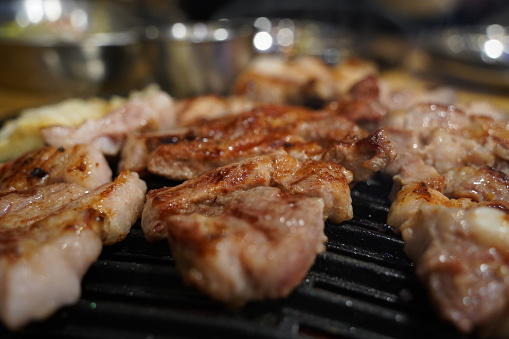 Grilled pork belly on the grill in the restaurant