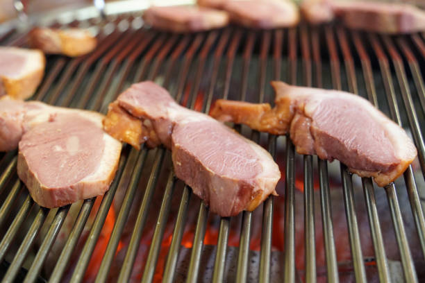 Duck meat is being grilled on the grill.