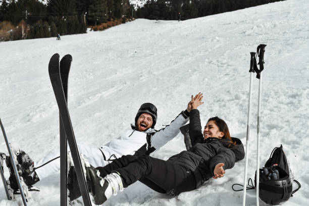 istock Fun Times For Excited Skiing Couple Having A High Five While Lying Down In Snow 2095078437