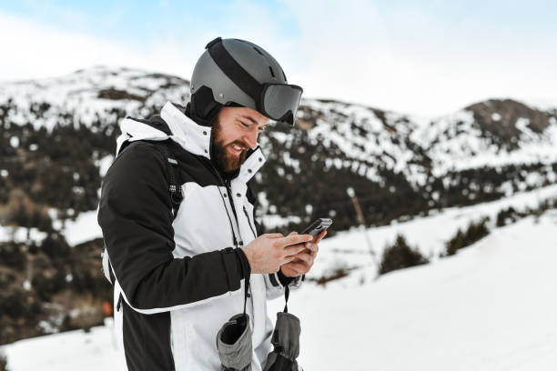 istock Male Texting Via Smartphone While Exploring Mountain And Skiing 2095087176