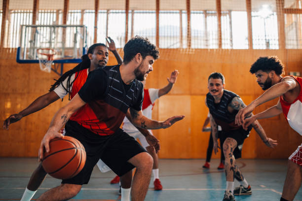 istock Interracial basketball team is practicing basketball on training. 2095117516