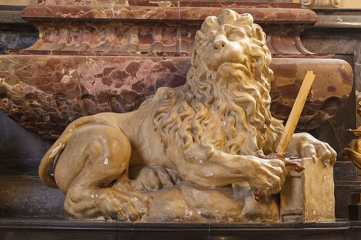 Lion statue on the ornate marble count Leopold Schlick inside Saint Vitus' Cathedral in Prague Castle in Prague, Czech Republic.