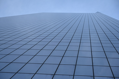 golden glass facade of modern  office building and blue sky -
