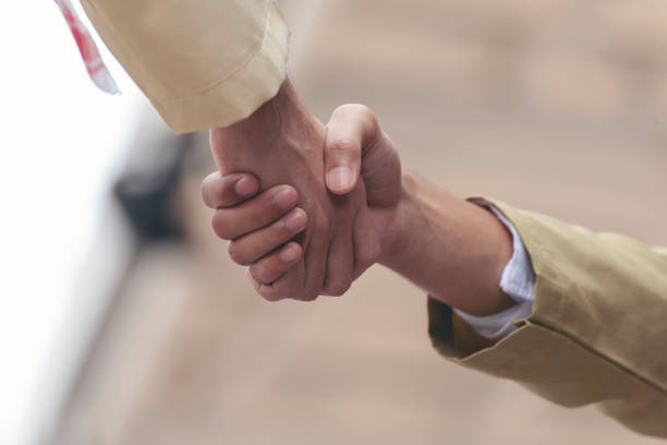 arab businessman shaking hands together. teamwork business partner wear muslim dress shake hands with partnership concept. success uae diversity people trust make commitment by handshake - sheik abu dhabi united arab emirates asia foto e immagini stock